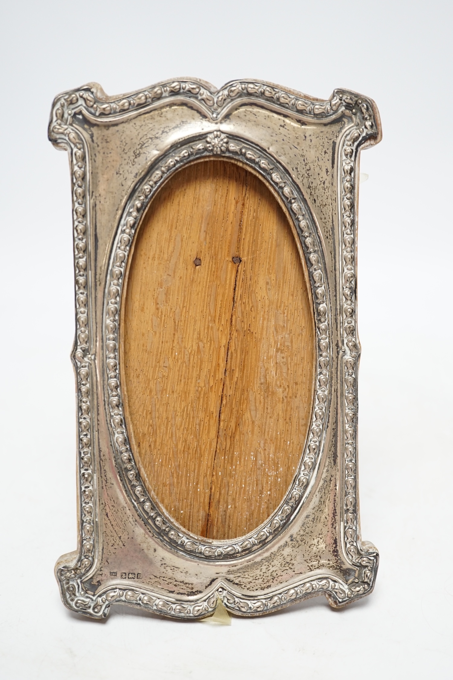 An Edwardian silver mounted photograph frame, Charles S. Green & Co, Birmingham, 1906, 19cm. Fair condition.